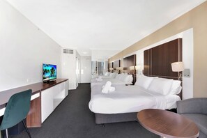 A hotel room with a bed, a desk, a chair, a TV, and a small table. - Cozy 2 Double-bed Hotel Room | Max 4 guests (Surfers Paradise)