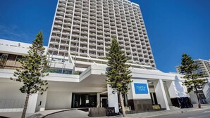 A tall hotel with a modern design, featuring a prominent entrance and a sign for 'Mantra On View Hotel.' - Cozy 2 Double-bed Hotel Room | Max 4 guests (Surfers Paradise)