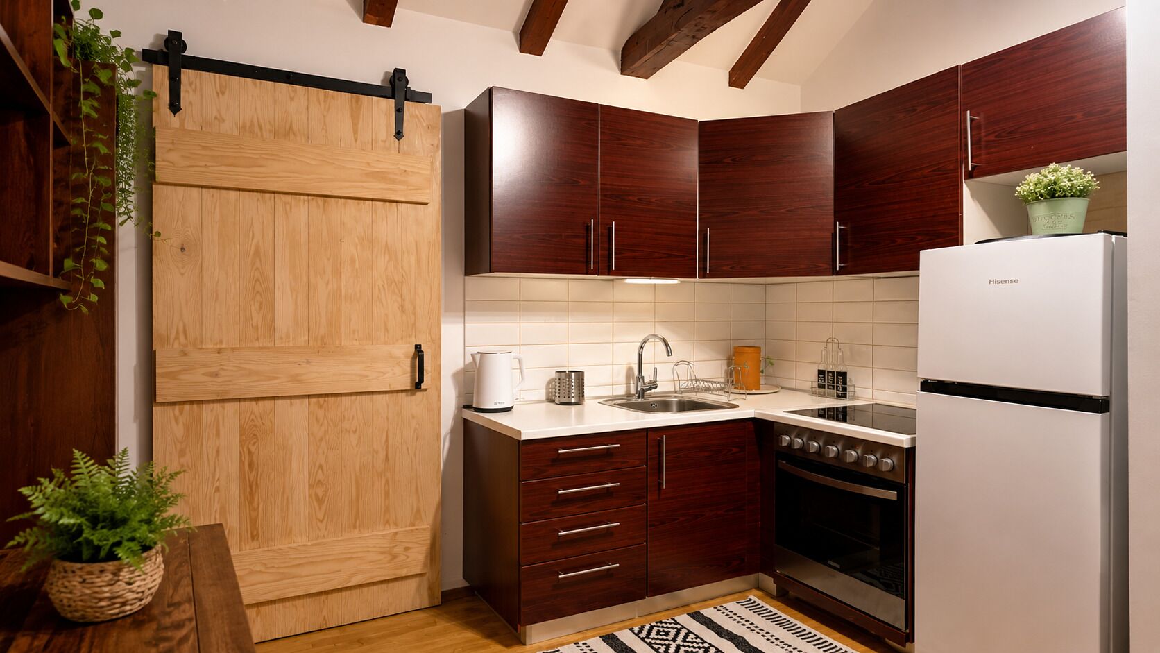 A kitchen with wooden cabinets, a white refrigerator, a stove, and a sink.
