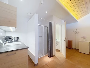 A modern kitchen with a built-in oven, a coffee machine, and a sink. - Sweet Edelweiss 5a by Interhome (Kaprun)