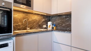 A modern kitchen with a built-in microwave, stainless steel sink, and a coffee maker. - Zeewind "close to the beach" by Interhome (Blankenberge)