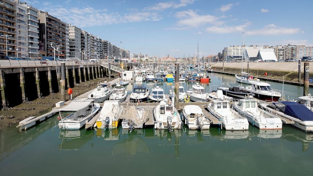A marina with boats docked, a bridge, and buildings in the background. - Zeewind "close to the beach" by Interhome (Blankenberge)
