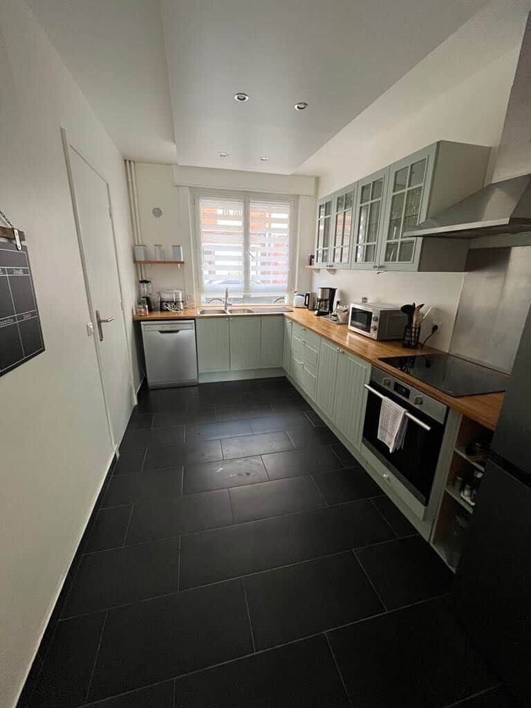 A compact kitchen with a dishwasher, microwave, and oven.