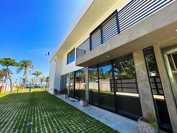 A modern two-story building with large windows and a flat roof.