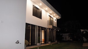 A modern two-story building with large windows and a balcony. - Gorgeous home with direct access to the Ocean (Conchalio)