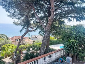 A residential area with a large tree, a swimming pool, and houses with red roofs. - A Casa di amici by Interhome (Marina di Andora)