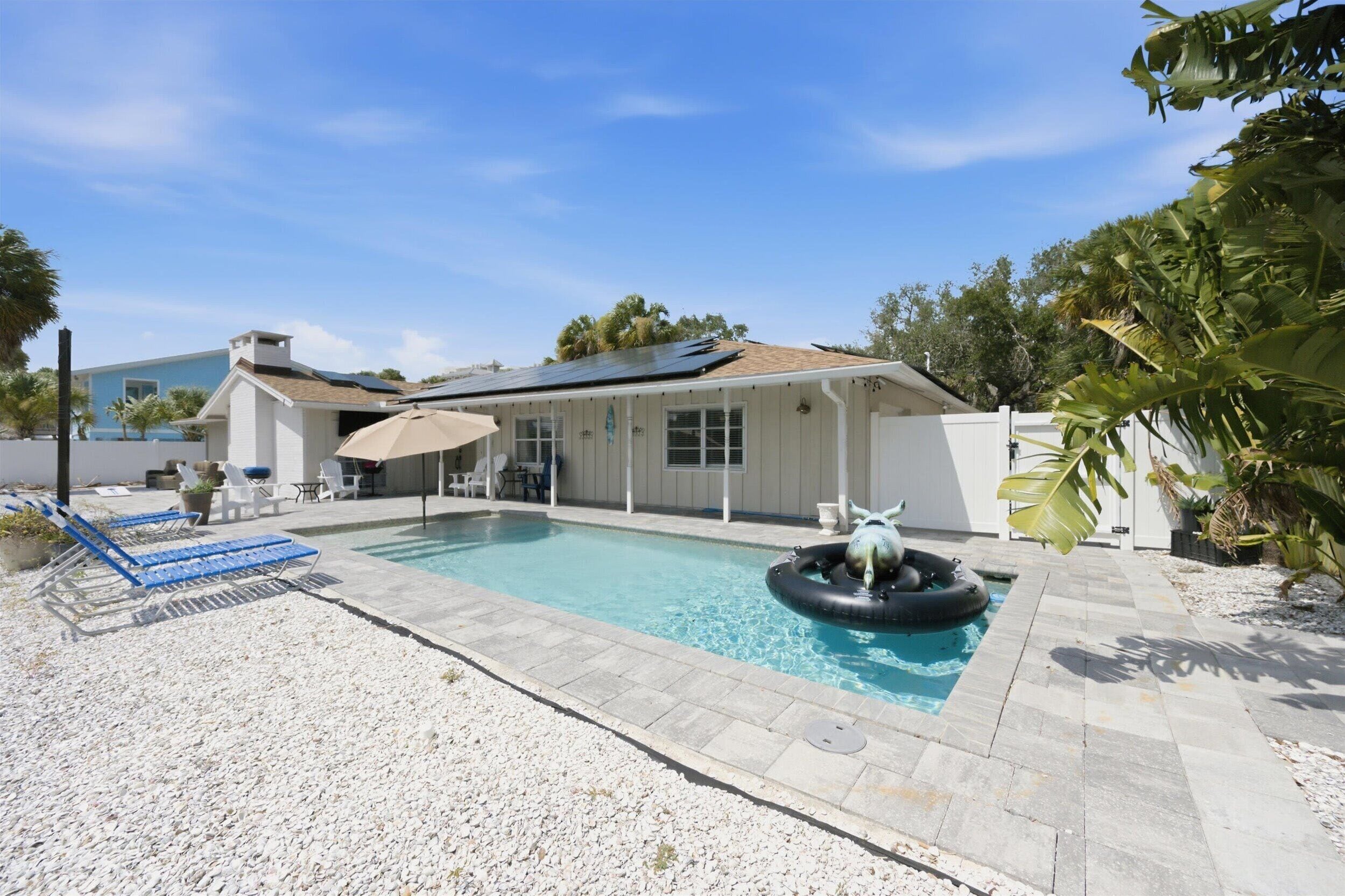 The property features a tropical oasis with its own private pool, surrounded by lush palm trees and spacious outdoor lounging areas—perfect for sun-soaked afternoons and ultimate relaxation.