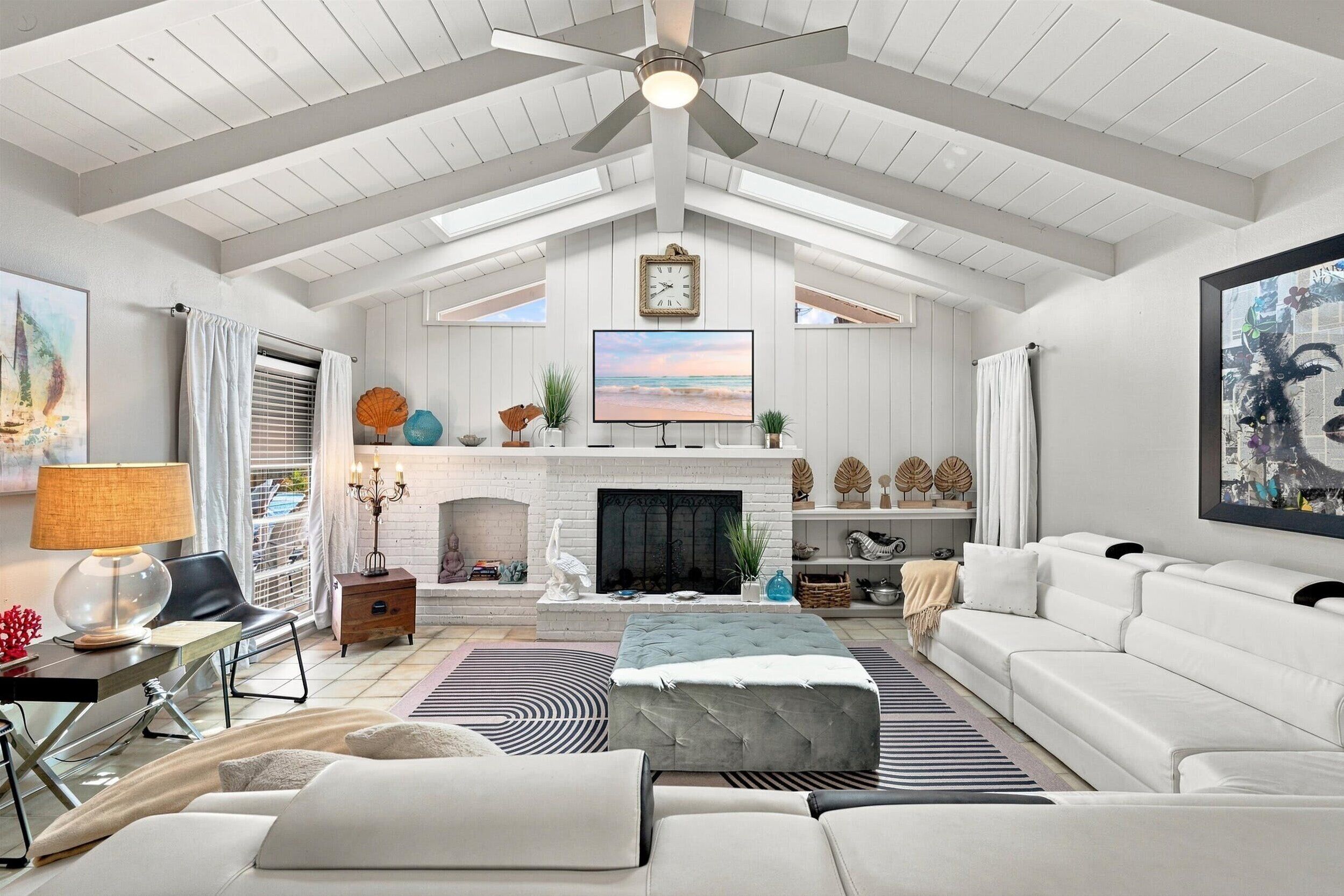 Relax in your bright, open living room with vaulted ceilings, a cozy fireplace, and plush seating perfect for unwinding after a day of exploring.