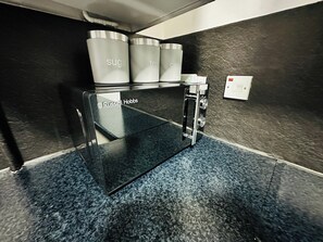 A self-service coffee machine with labeled containers for sugar and tea. - Hockley 4-Bed, Sleeps 12 w/ Garden & Free Parking (Birmingham)
