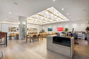 A modern interior with a dining area, kitchen, and living space.