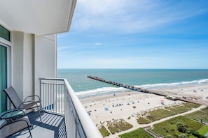 A balcony with a view of a beach, a pier, and the ocean. - Amazing Oceanfront Views at Carolinian with Pool (Myrtle Beach)