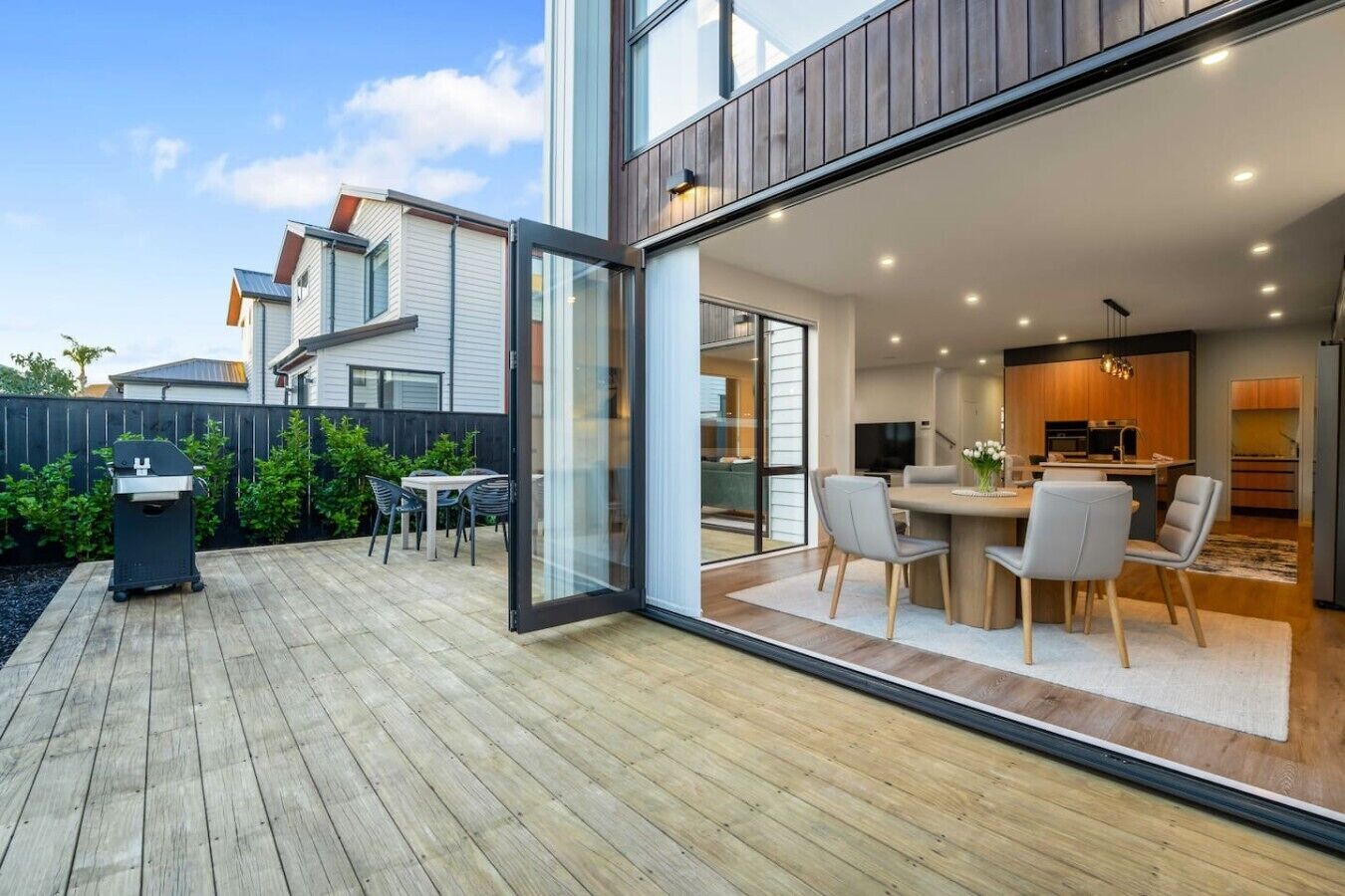 A modern house with a patio, a dining area, and a kitchen.