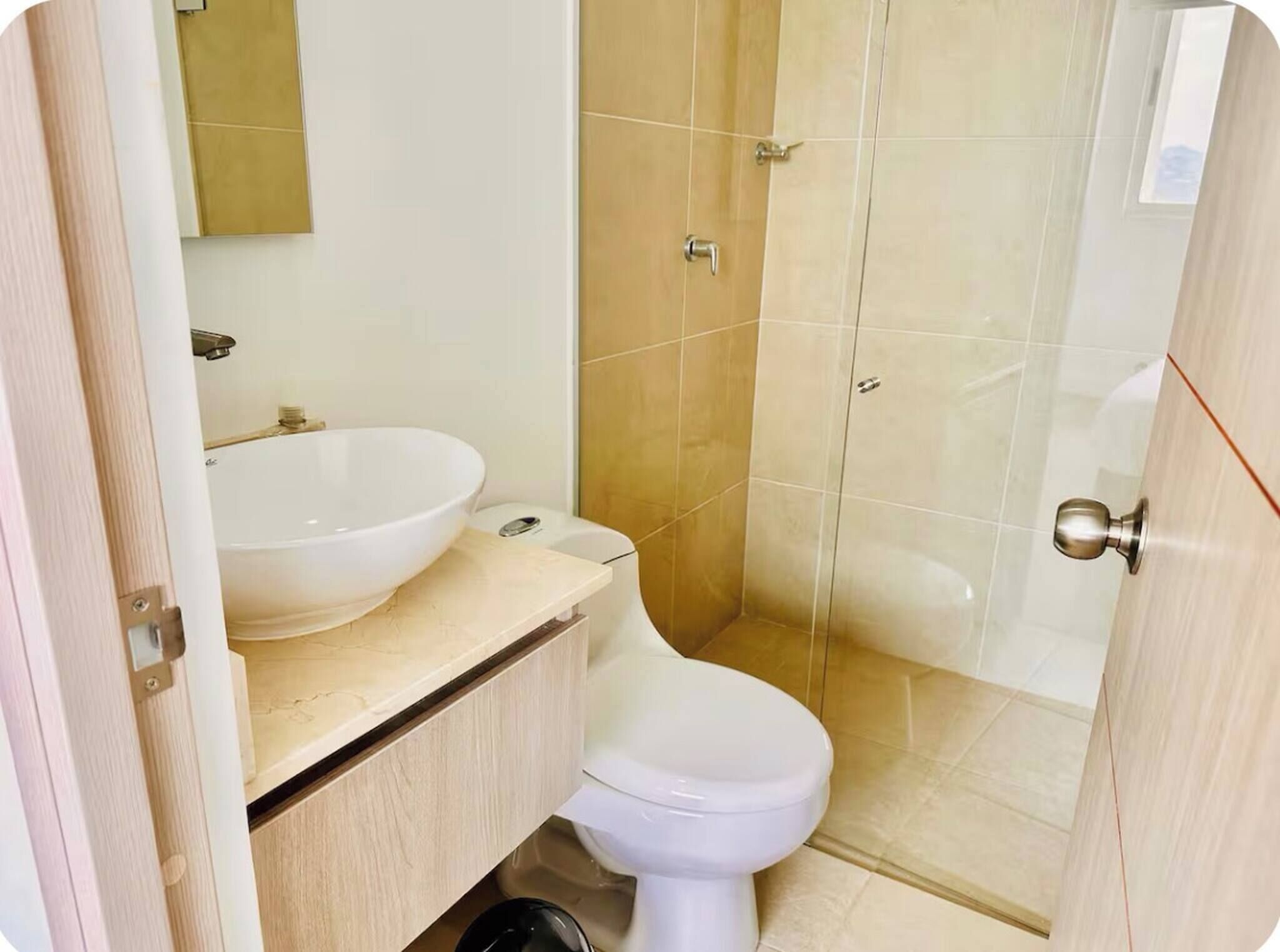 A bathroom with a sink, toilet, and shower.