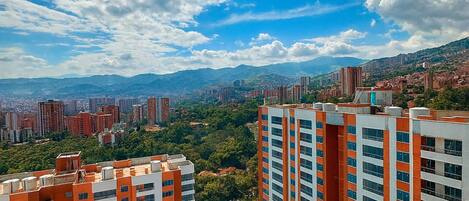 High-rise buildings with a clear view of the surrounding cityscape and mountains in the distance.