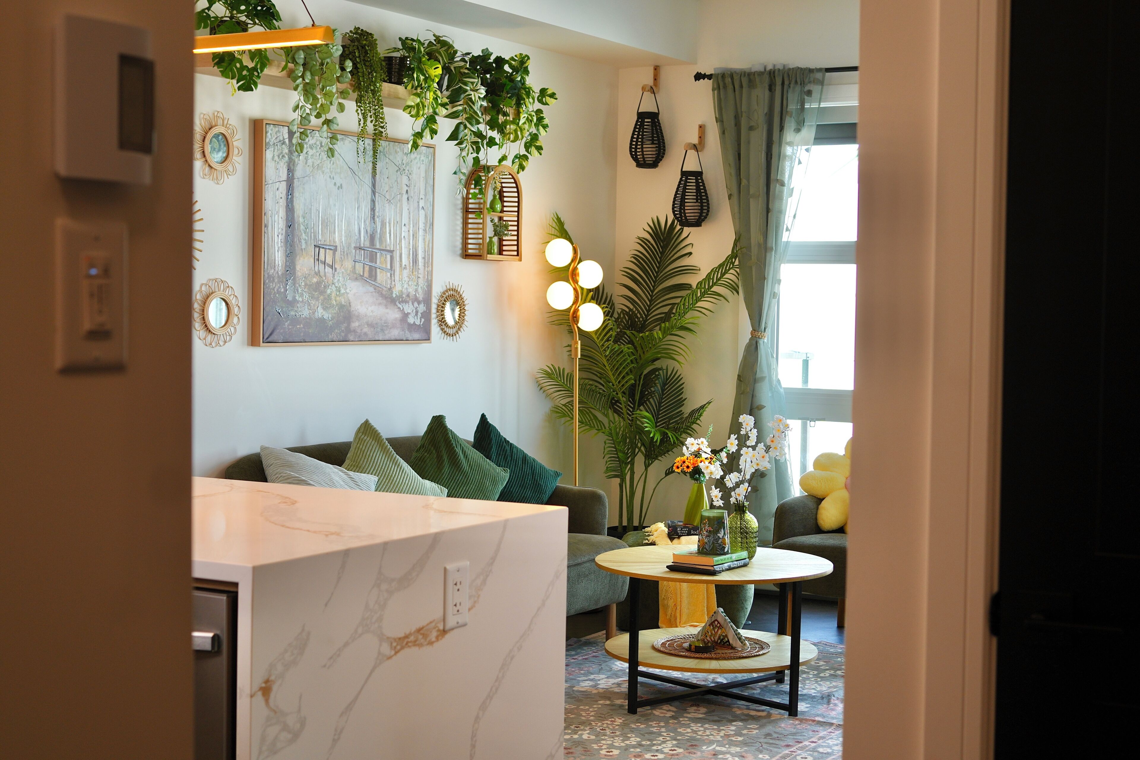 A modern living room with a sofa, coffee table, and decorative plants.