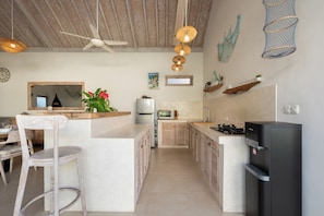 A modern kitchen with a central island, a built-in oven, a refrigerator, and a water dispenser. - 2 BR Villa Bali Pearl Stay Between Dream and Reality in Seminyak (Badung)