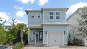 A two-story house with a front porch, a garage, and a driveway. - Boho-Chic House Near 30A Beach w/ Pool & Hot Tub (Santa Rosa Beach)