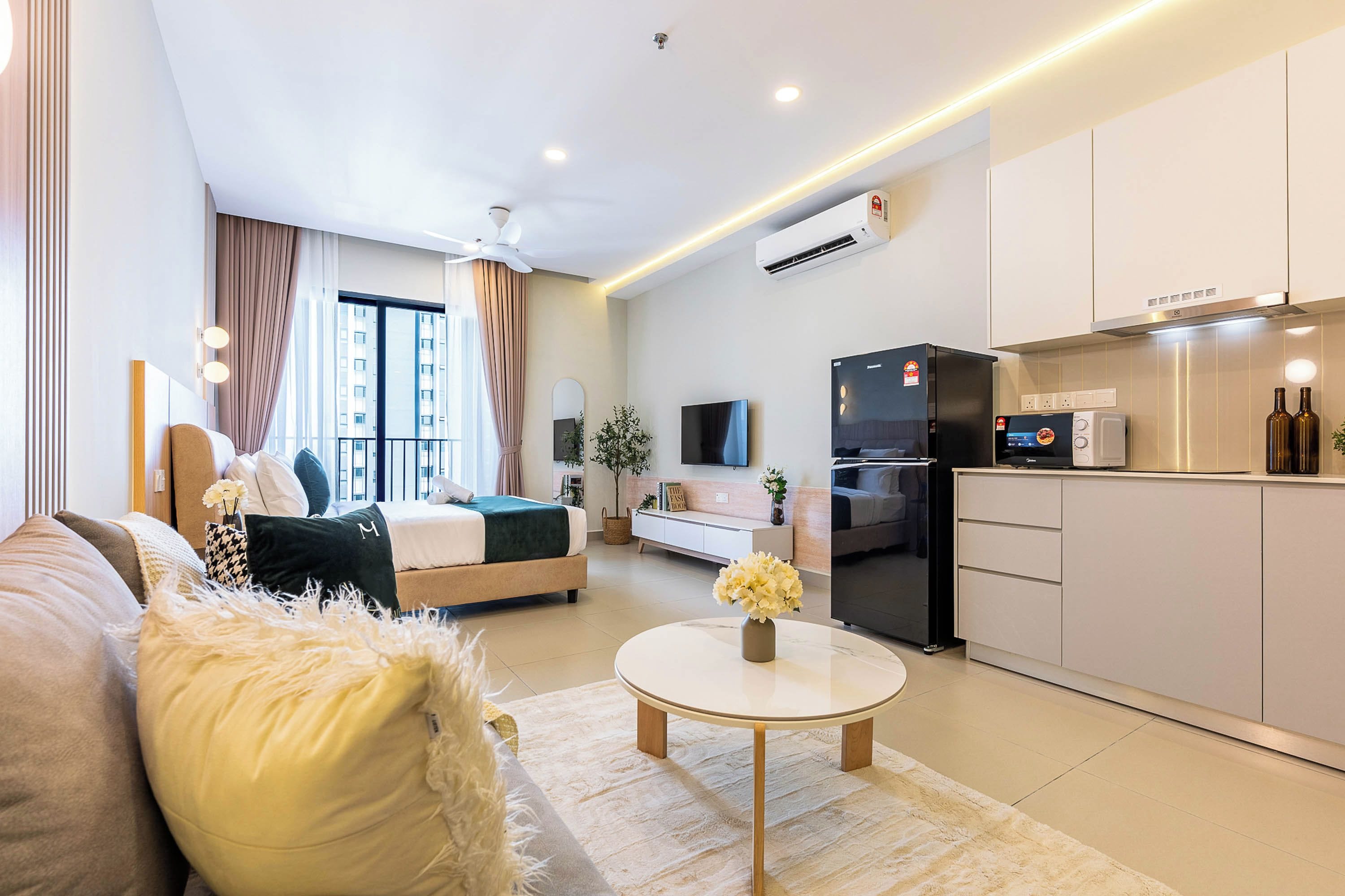 A modern apartment with a living room, bedroom, and kitchen area.