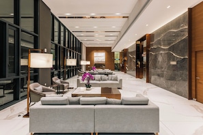 A modern lobby with a sofa set, floor lamps, and a large abstract painting. - Skyline Premier Suites Kuala Lumpur (Kuala Lumpur)