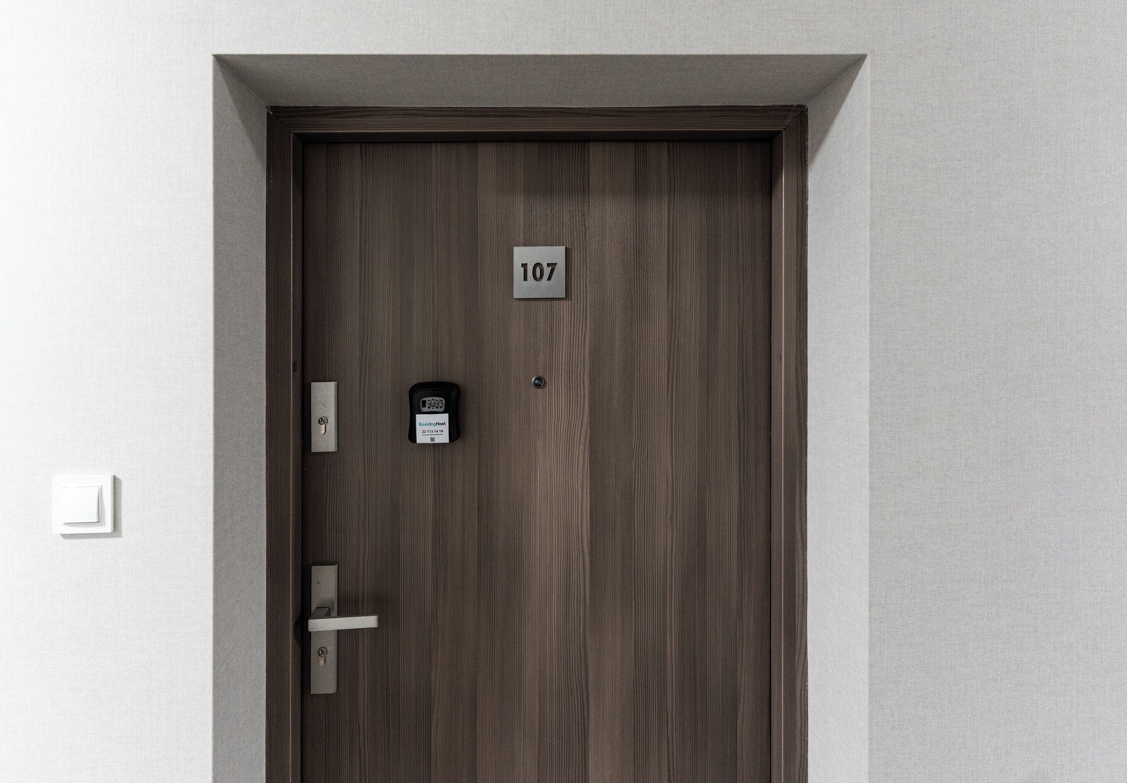 A door with a number plate, a keyhole, and a lock.