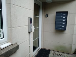 A building entrance with a mail slot, a door, and a mailbox. - Prescott Seaside M4 Porthcawl beach (North Cornelly)