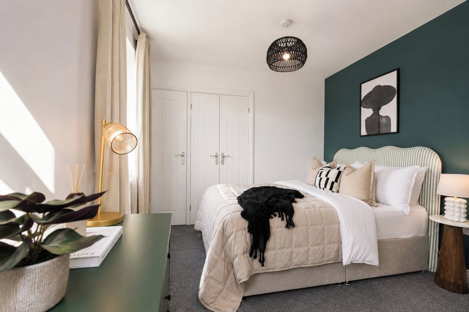 A bedroom with a bed, bedside table, lamp, and a wall-mounted light fixture.