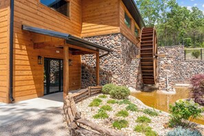A rustic water wheel and stone mill add Ozark character to the camp's landscaped grounds. - New 6BR Cabin with Hot Tub, Fire Pit, Indoor Pool - Game Table, Shuffleboard (Hollister)