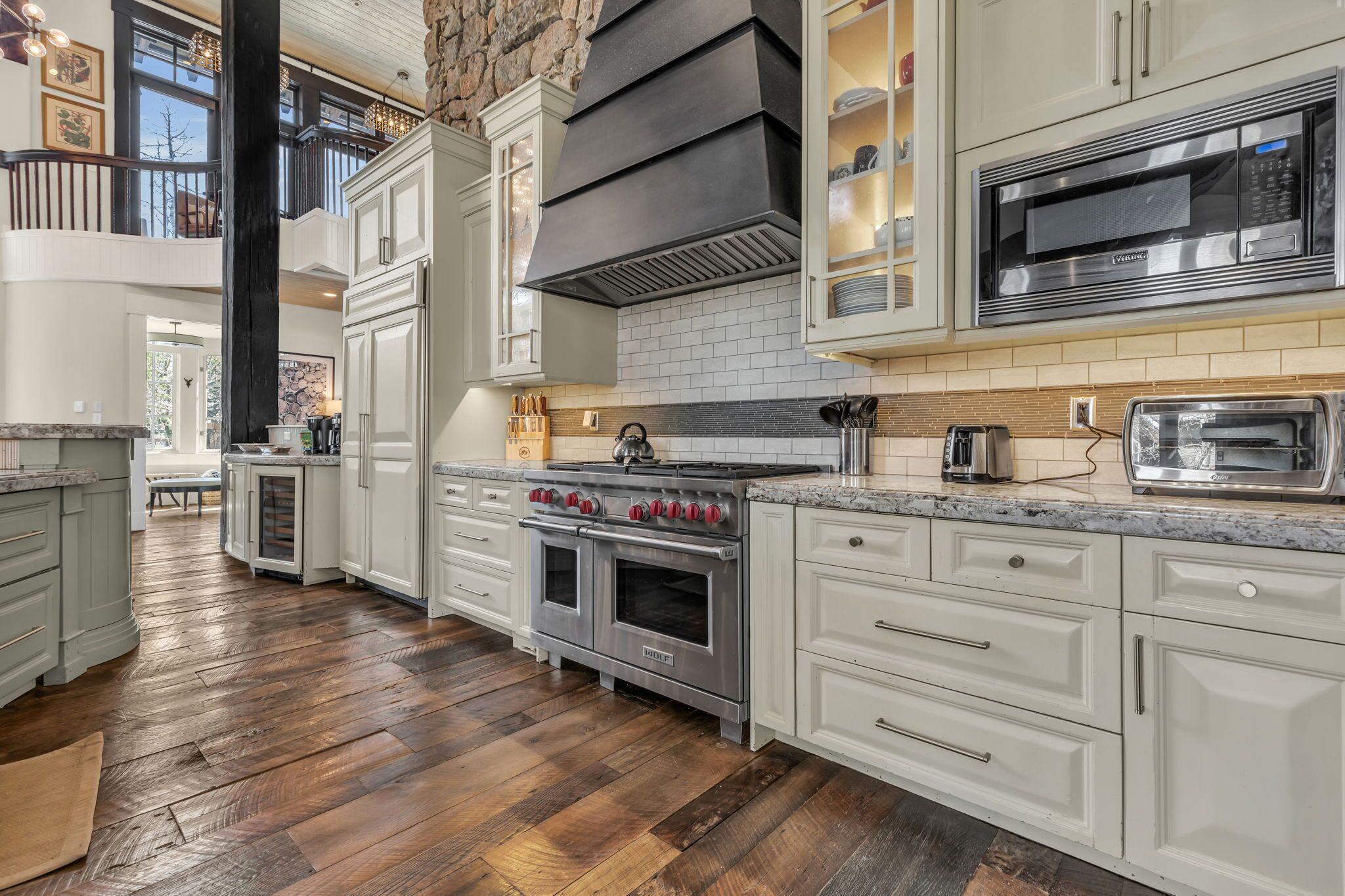 A kitchen with a large stove, oven, and microwave.