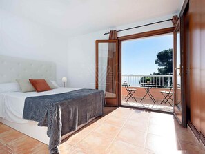 A bedroom with a bed, a balcony with a table and chairs, and a view of the outdoors. - 'Chalet Mirador', with panoramic views of the Mediterranean Sea (Alcudia)
