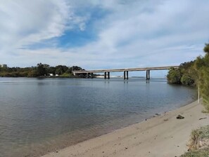 A river with a bridge, a sandy beach, and a clear sky. - Surf, Beach, Fishing, Fishing, Relaxing, SUP, paddling, Restaurants, cafes (Currumbin)