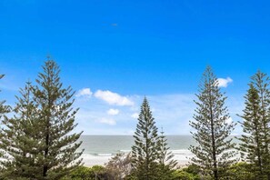 A coastal landscape with trees and a beach. - Iconic Burleigh Beachfront, 2 Bedroom Apartment (Gold Coast)