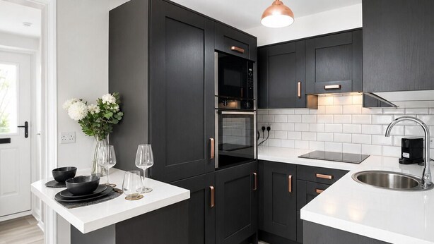 A modern kitchen with dark cabinetry, a white countertop, stainless steel appliances, and a pendant light. - Modern Central Dublin Apartment  Near Bolton Square (Dublin 1)