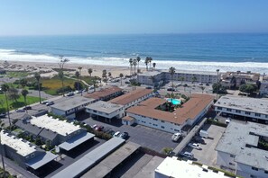 A coastal hotel with multiple buildings, a parking lot, and a view of the ocean. - Lovely 1-bedroom condo in Carpinteria steps from the beach (Carpinteria)