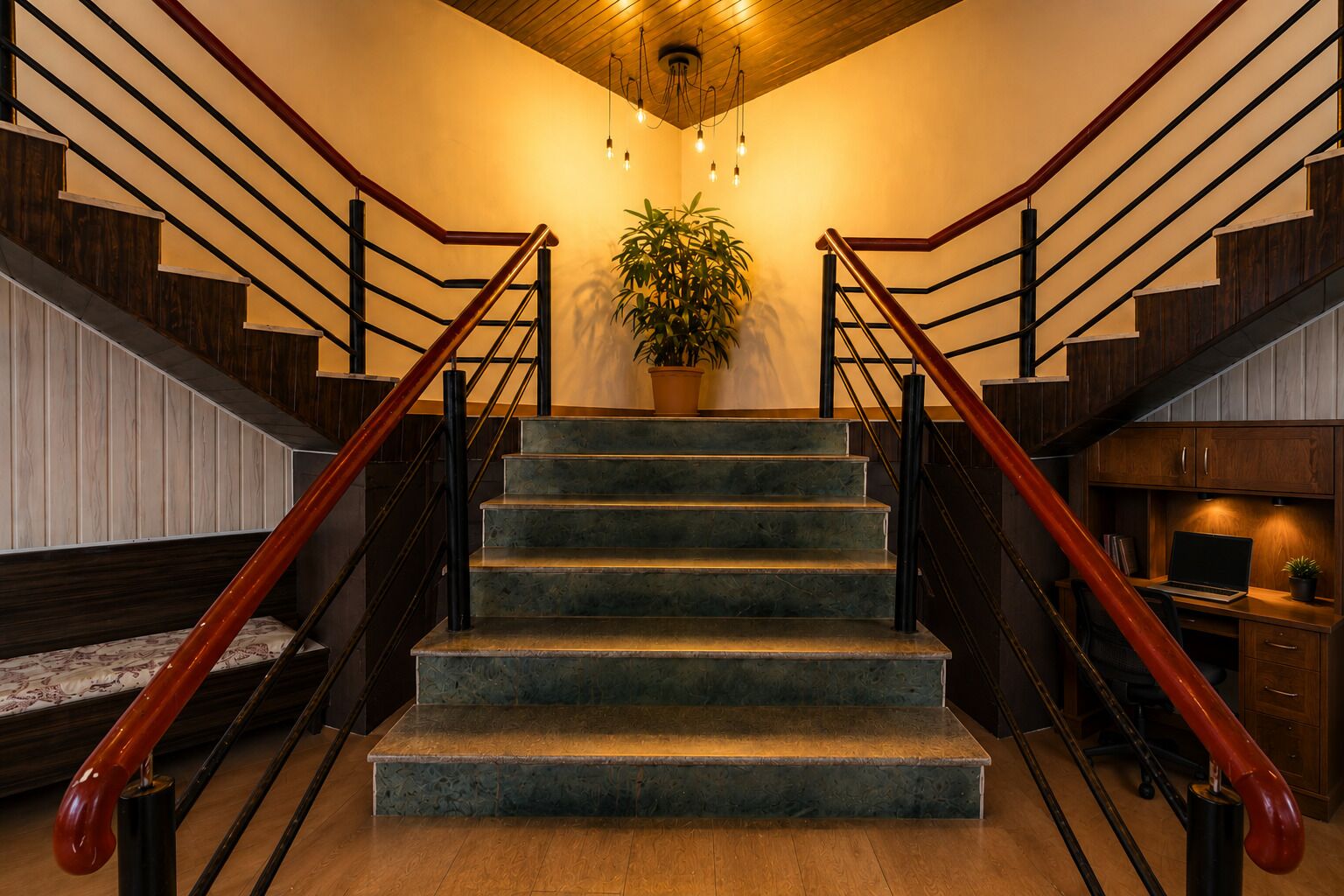 A staircase with wooden railings and a potted plant at the top.
