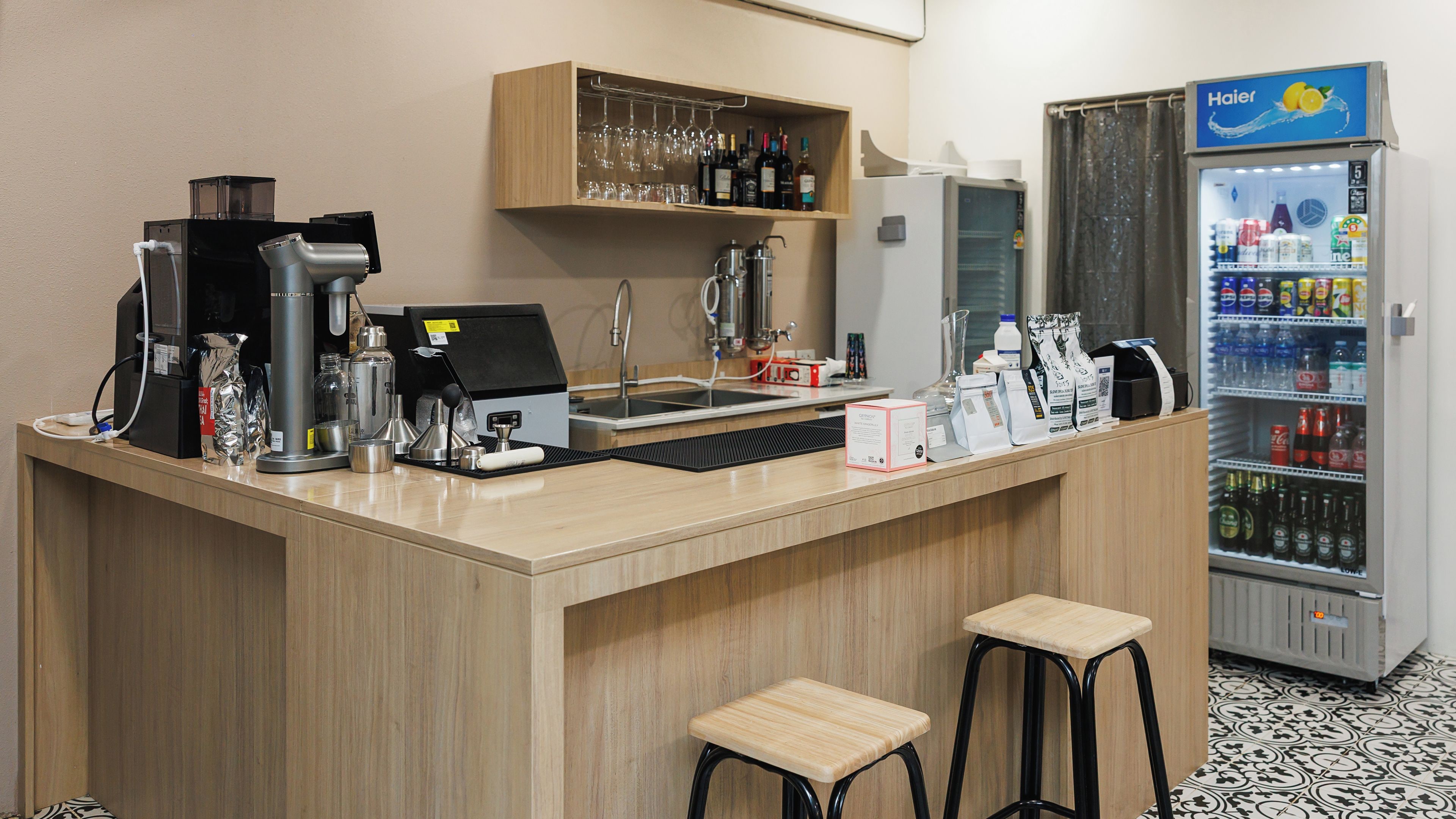 A bar area with a coffee machine, a wine cooler, and a beverage dispenser.