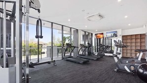 A gym with treadmills, elliptical machines, and free weights. - Sea Glimpse Escape at Sandbar Burleigh (Gold Coast)