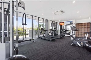 A gym with treadmills, elliptical machines, and free weights. - Sea Glimpse Escape at Sandbar Burleigh (Gold Coast)