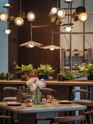 A dining area with a round table, chairs, and a variety of tableware. - JEN Kunming by Shangri-la (Kunming)