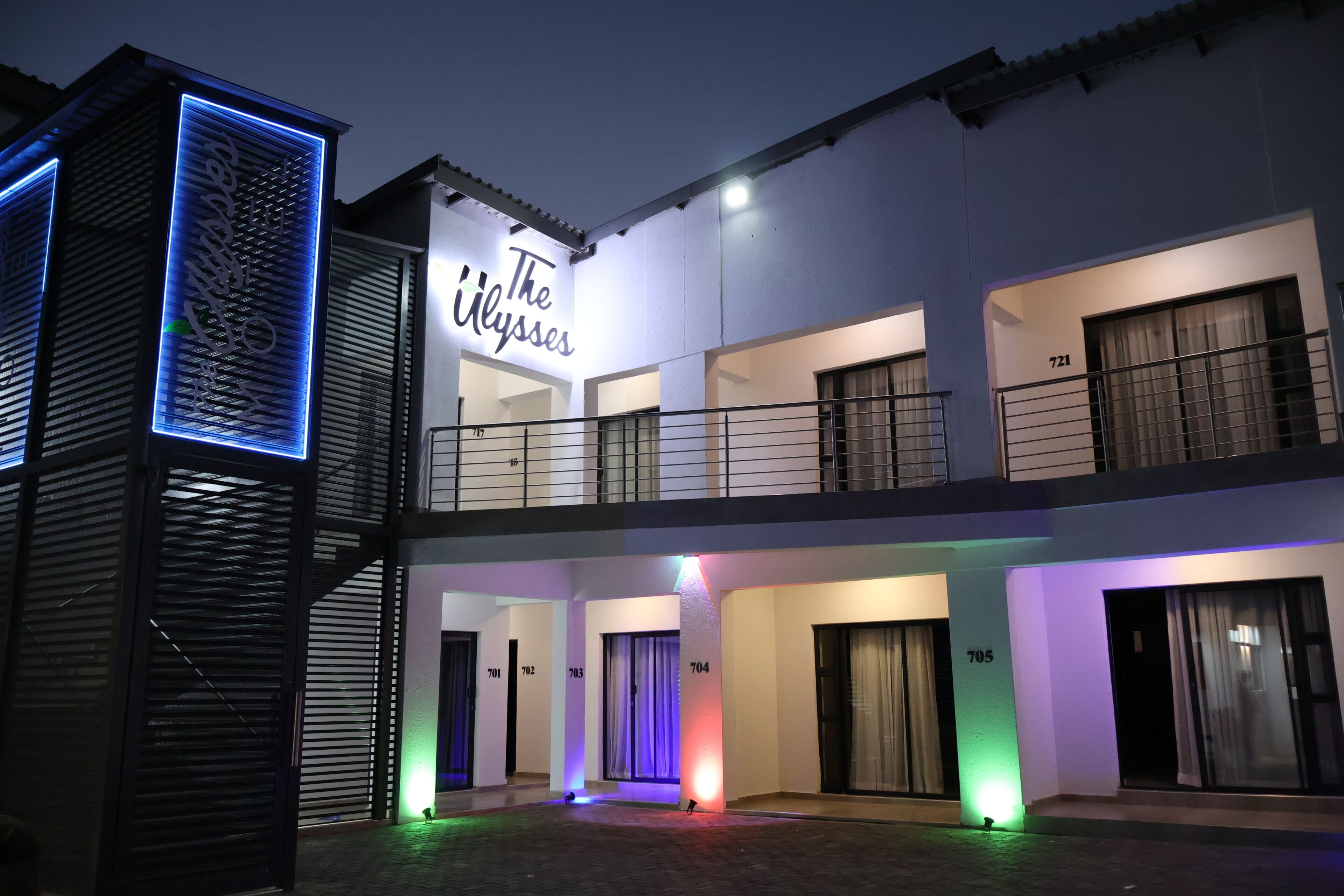 A multi-story hotel with balconies and a sign reading 'The Ulysses.'