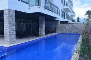A modern house with a swimming pool, stone pillars, and a balcony. - Holiday Homes - Newtown Apartment 1 (Nadi)