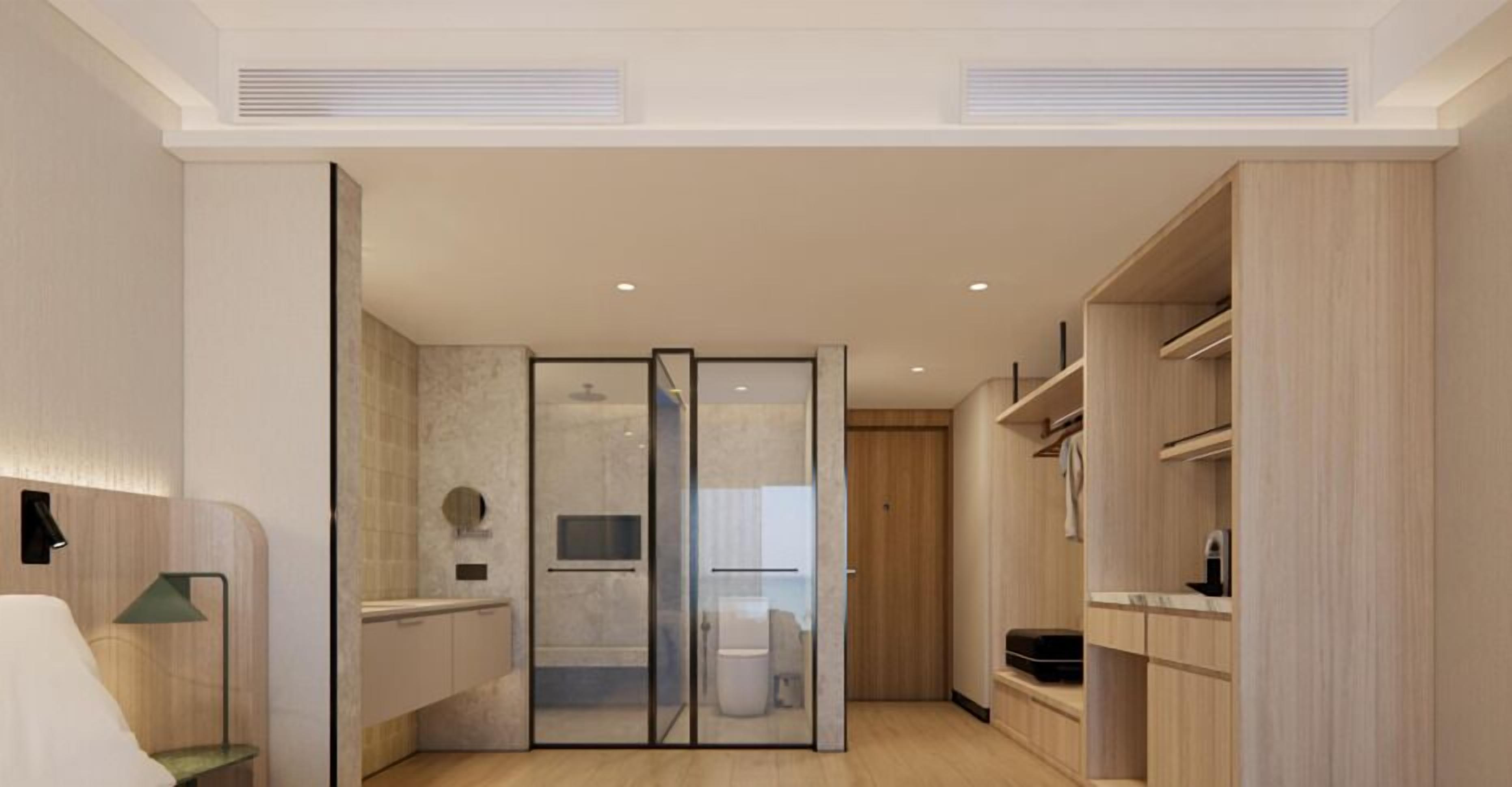 A modern bathroom with a shower, toilet, and vanity.