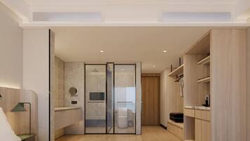A modern bathroom with a shower, toilet, and vanity.