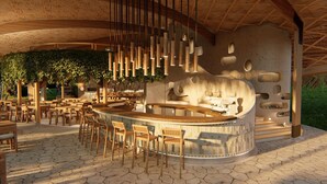 A restaurant with a curved bar, wooden chairs, hanging light fixtures, and a thatched ceiling. - Vikasa Evolution Retreat Phuket (Koh Lon)