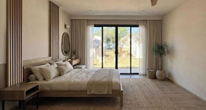 A bedroom with a large bed, a nightstand, a mirror, and a view of the outdoors through a sliding door. - Vikasa Evolution Retreat Phuket (Koh Lon)