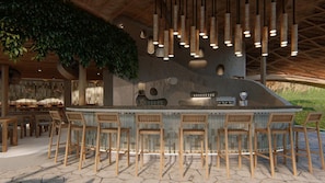 A bar area with a stone counter, wooden chairs, and hanging bamboo lights. - Vikasa Evolution Retreat Phuket (Koh Lon)