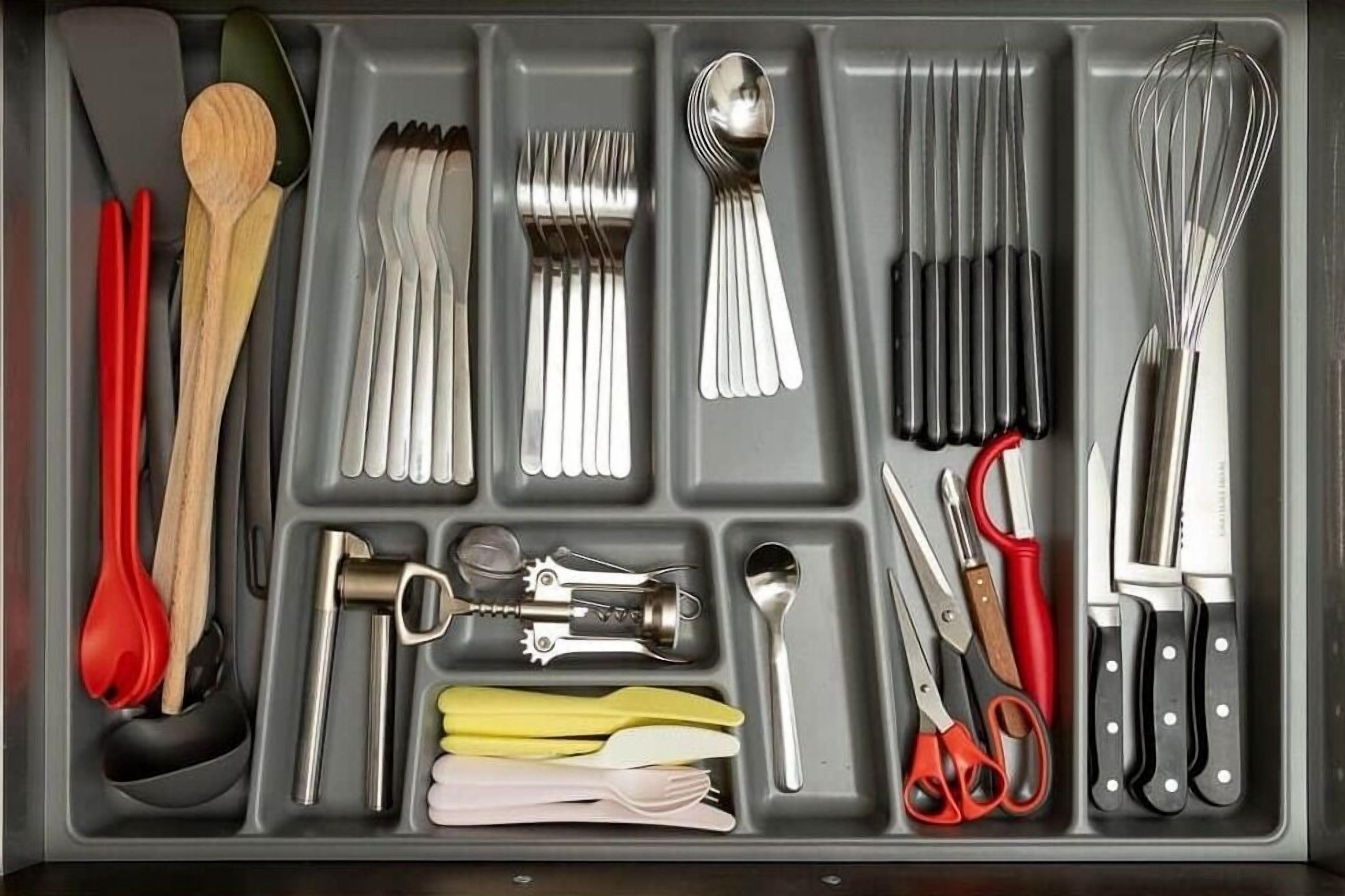 A kitchen drawer with utensils and tools organized in compartments.
