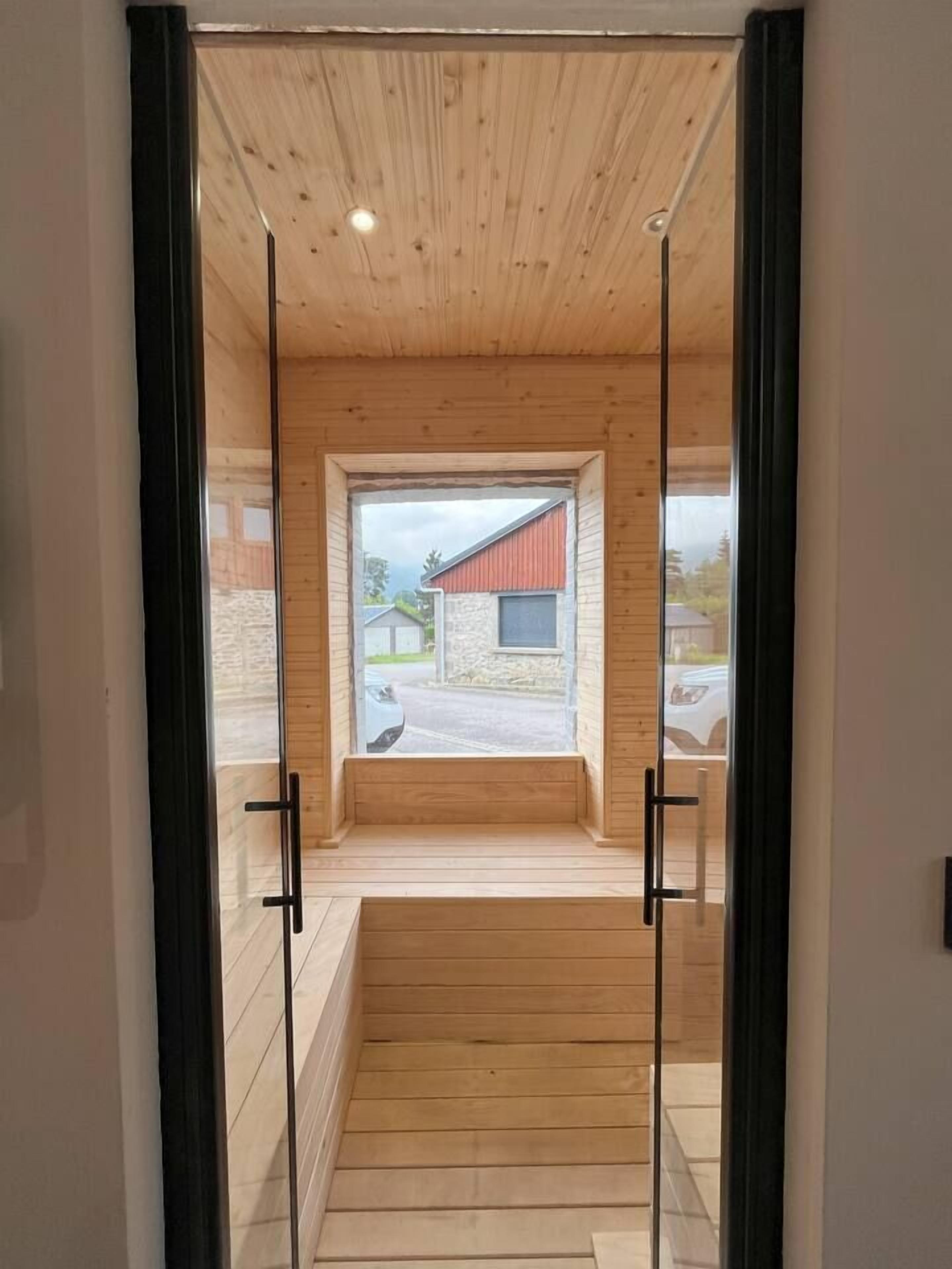 A wooden interior with a glass door leading to an outdoor area.