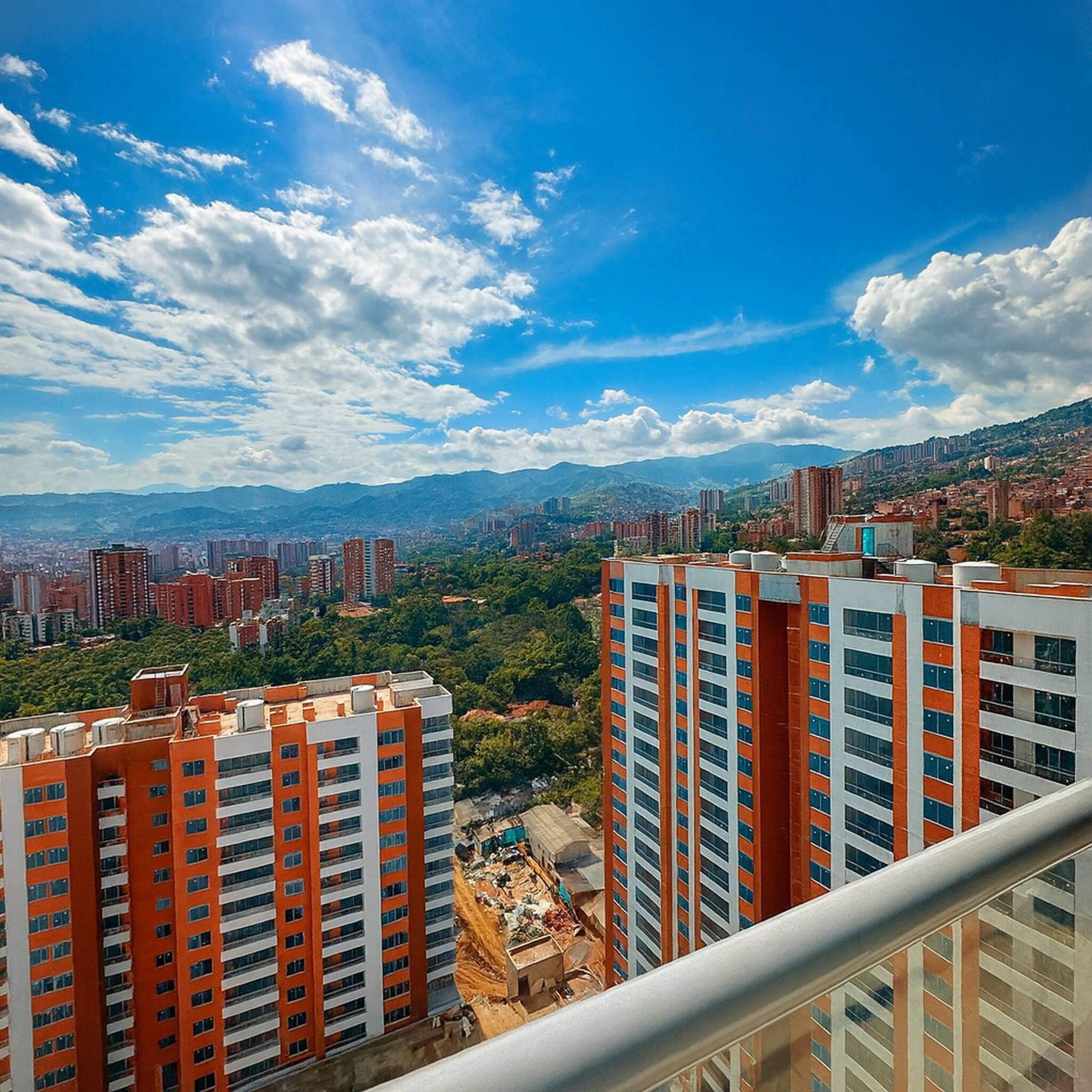 High-rise buildings with a clear view of the surrounding cityscape and mountains in the distance.