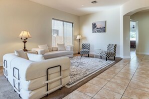 A living room with a sofa, armchairs, a patterned rug, and a painting on the wall. - 5 Mi to Estrella Mtn Park! Home w/ Outdoor Oasis (Goodyear)