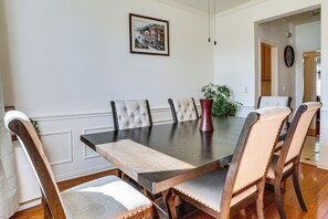 A dining room with a rectangular table surrounded by six upholstered chairs with button-tufted backs. - Arlington Home w/ Pool: Just Over 1 Mi to Stadium (Arlington)